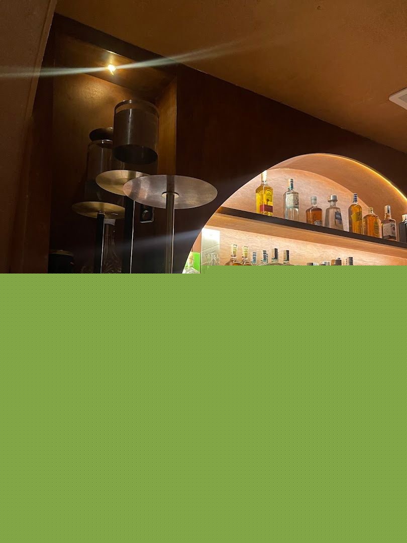Bar area with hookah pipes and premium spirits on display